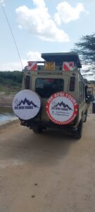 Safari jeep in Maasai Mara Kenya spotting cheetah on the plains